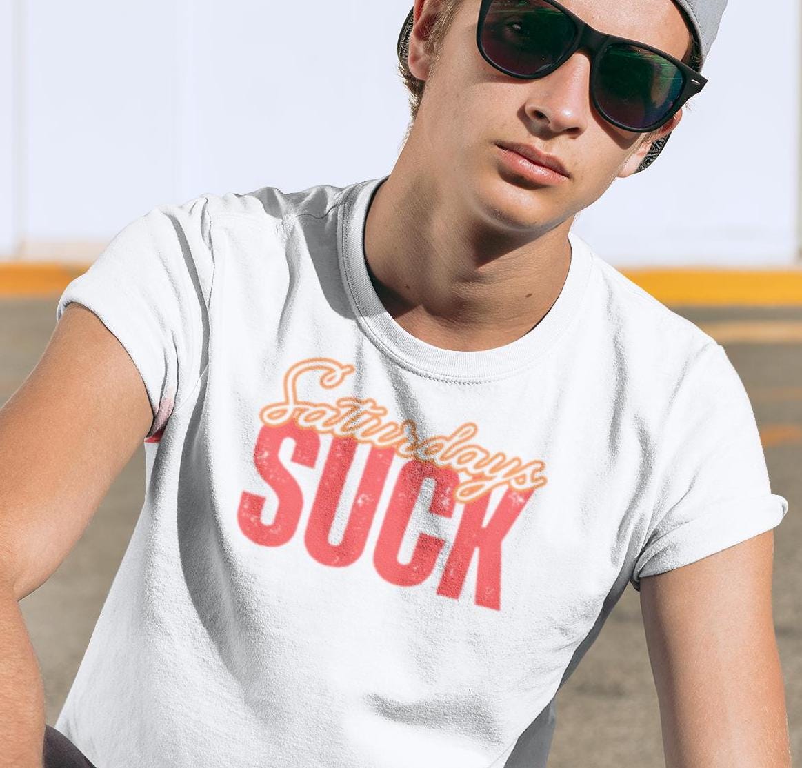 Saturdays SUCK Unisex Heavy Cotton Tee, Weekend Humor Graphic T-Shirt, Casual Tee, Relaxation Clothing, Gift for Him, Her, Unisex Tee Gift