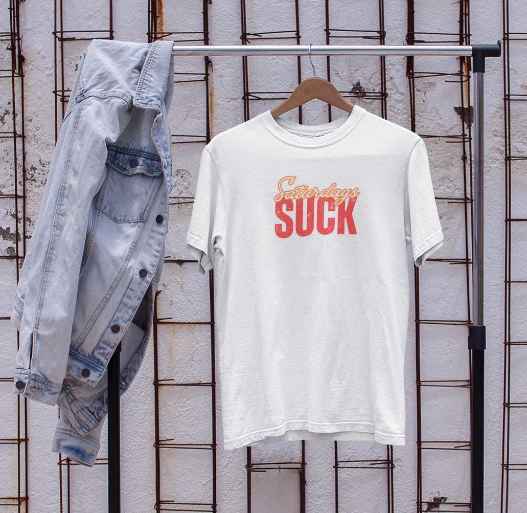 Saturdays SUCK Unisex Heavy Cotton Tee, Weekend Humor Graphic T-Shirt, Casual Tee, Relaxation Clothing, Gift for Him, Her, Unisex Tee Gift