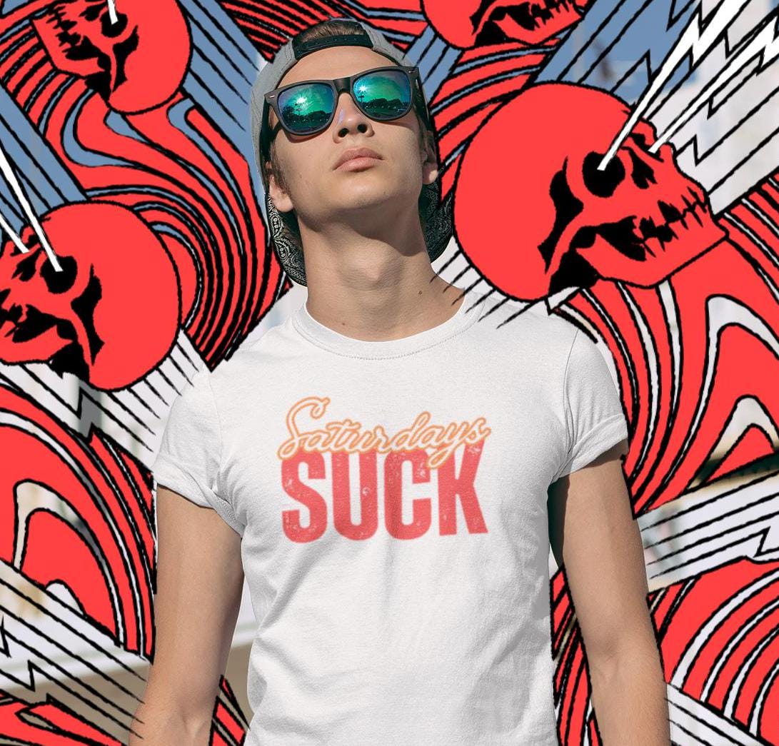 Saturdays SUCK Unisex Heavy Cotton Tee, Weekend Humor Graphic T-Shirt, Casual Tee, Relaxation Clothing, Gift for Him, Her, Unisex Tee Gift